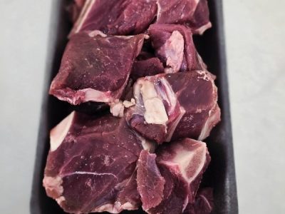 a tray of bone-in goat casserole.