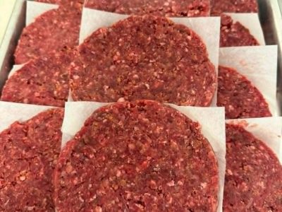 A tray of freshly made beef and jalapeno burgers.